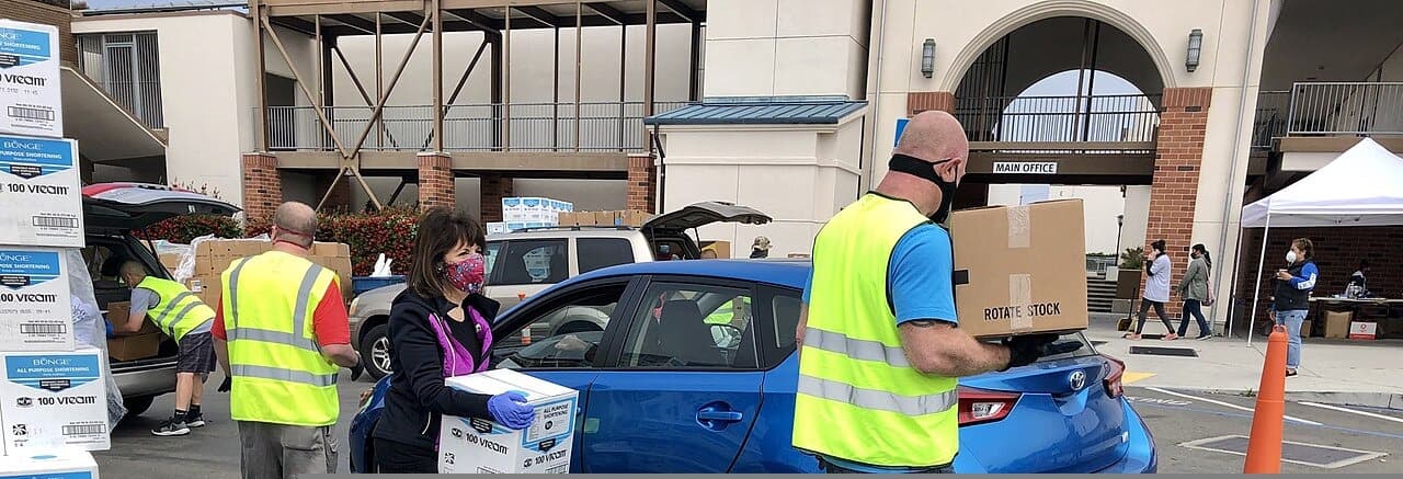 Volunteers loading boxes at a food bank distribution